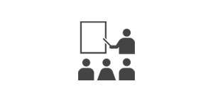 advanced training icon with person pointing at screen while students watch