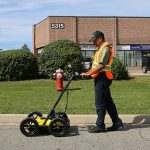 Person pushing lmx across pavement