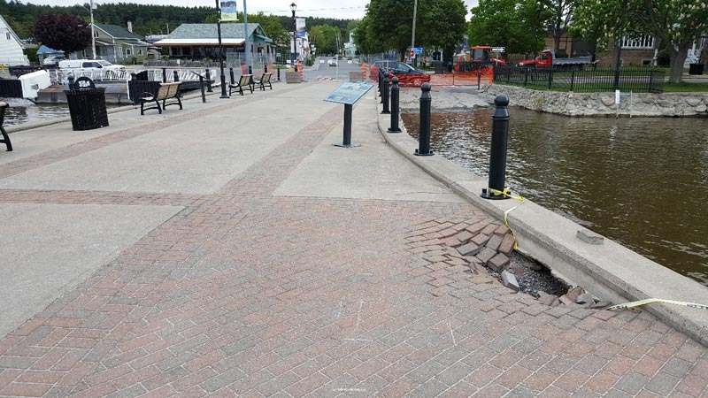 Surface of pier showing concrete and interlocking brick surface materials and a void. Surface of pier showing concrete and interlocking brick surface materials and a void.