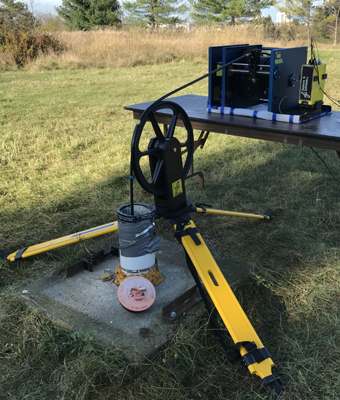 Motor-driven borehole winch with depth encoder. Motor-driven borehole winch with depth encoder.