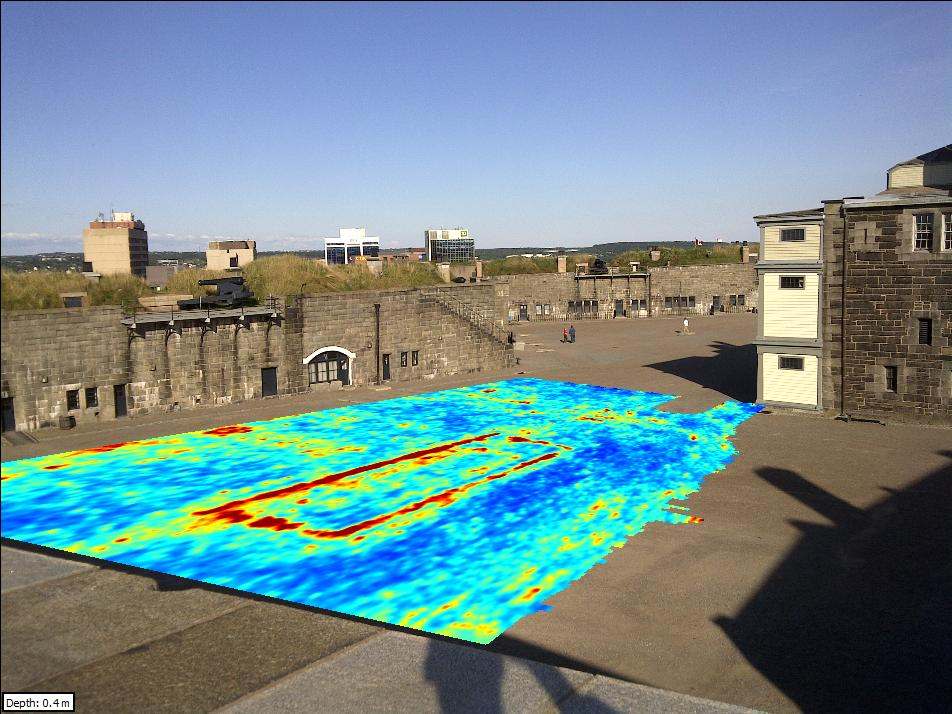 The foundations of a rectangular buried structure are shown on a photo of the site
