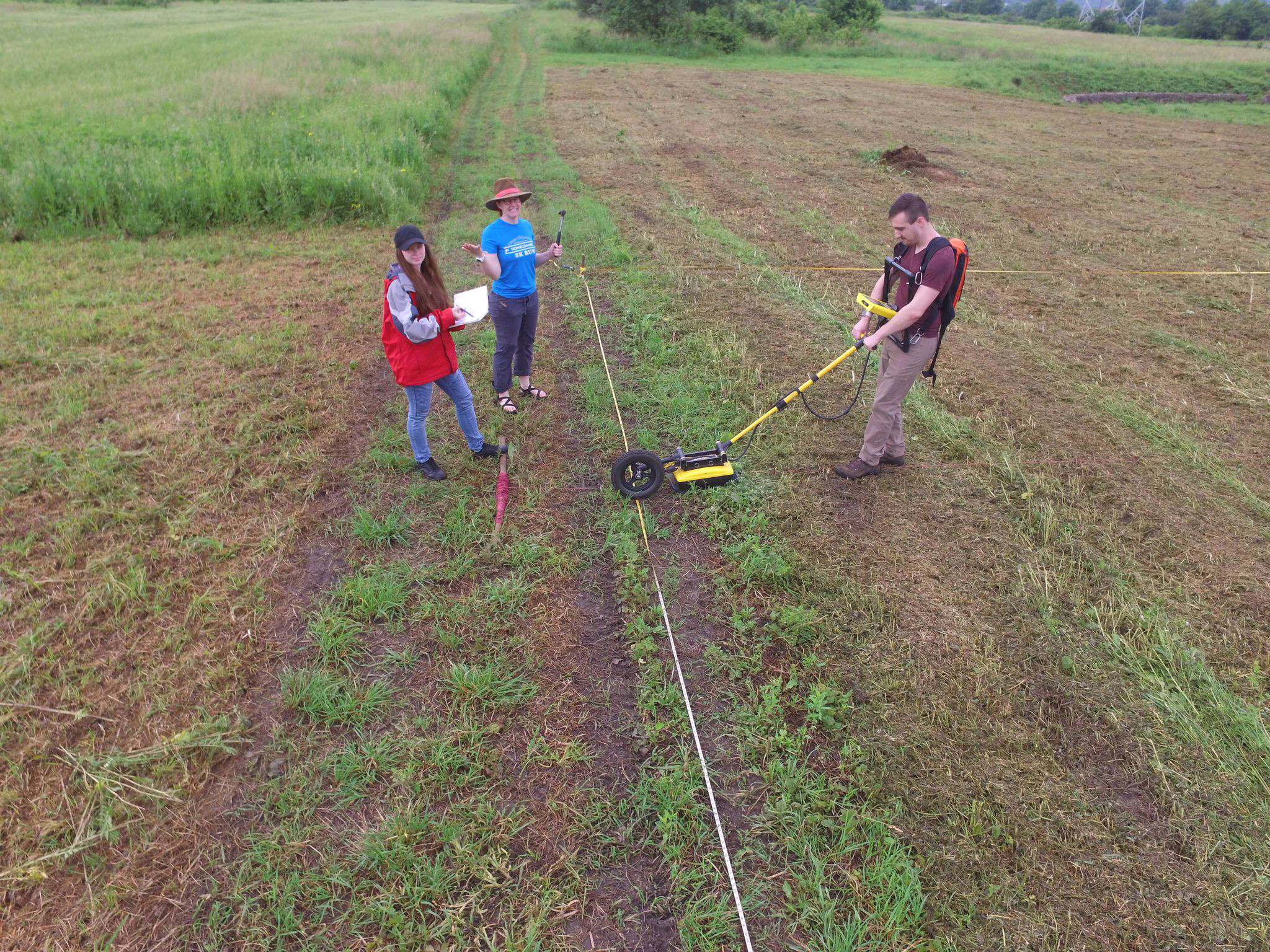 3 people using a Noggin 500 SmartTow on a field